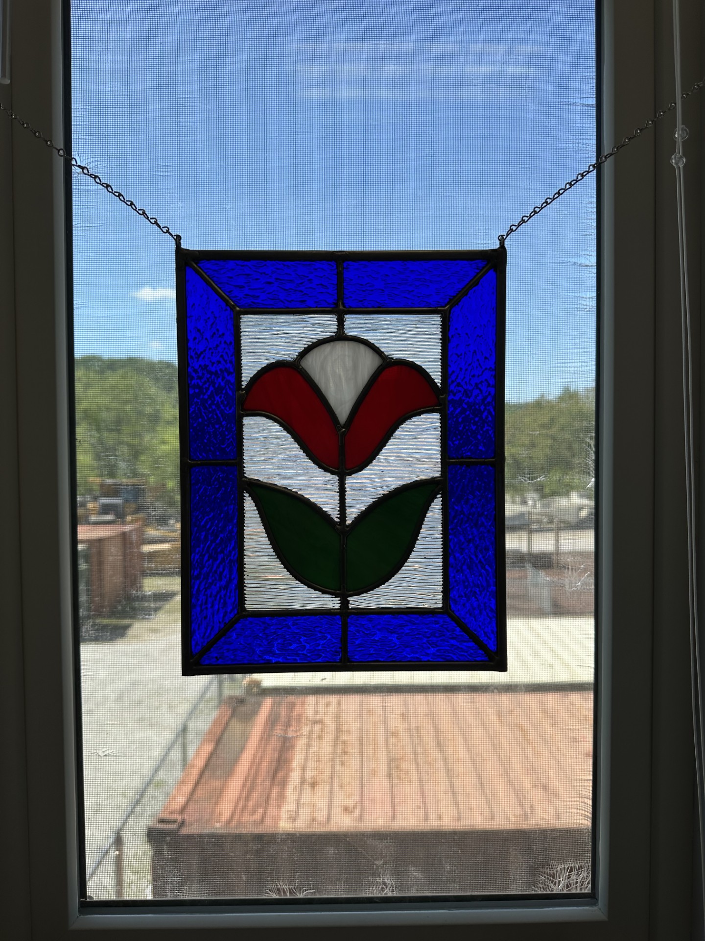 Small stained glass window depicting a tulip